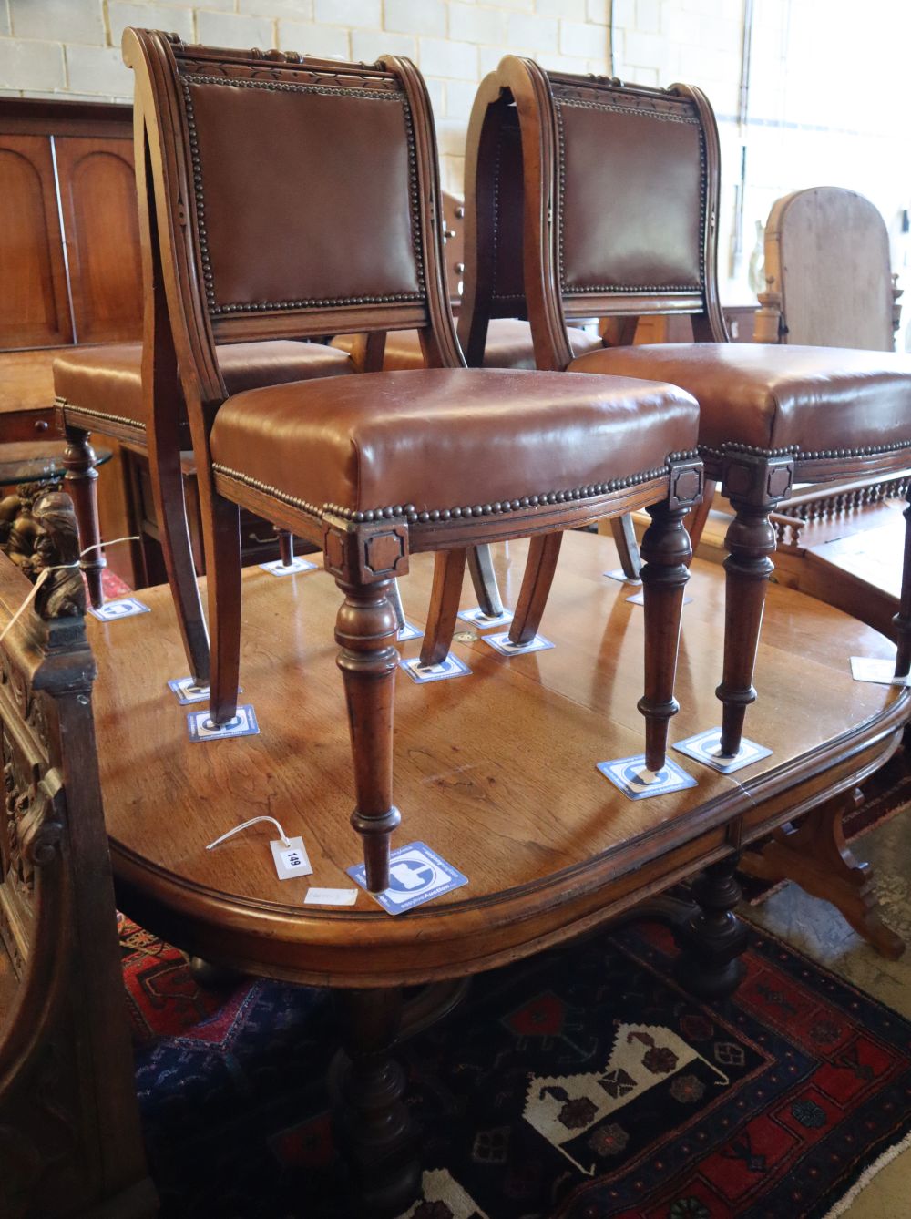 A late 19th century Continental walnut extending dining table, width 140cm, depth 124cm (no leaves) and four chairs